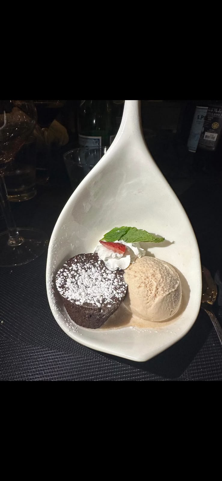 Chocolate dessert with gelato in a spoon-shaped dish